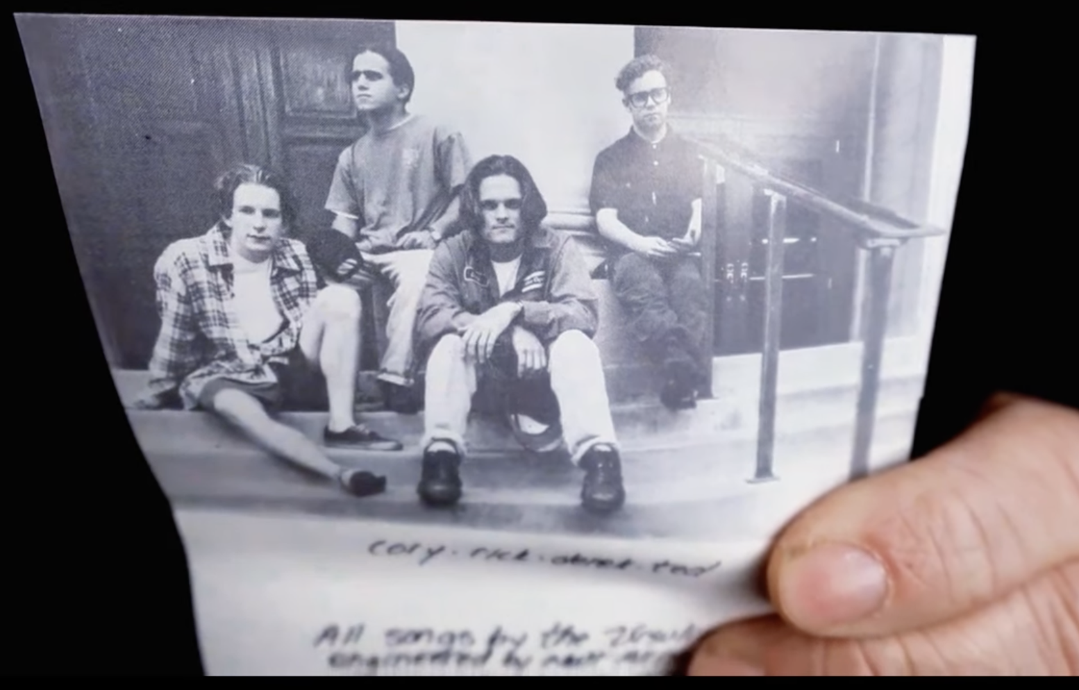 A very Genx band photo of The Ursulines. Four white dudes, black and white, on some stairs.